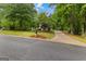 Landscaped front yard of home with long driveway and mature trees, showcasing the property's curb appeal at 40 High St, Sharpsburg, GA 30277