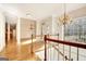 Foyer with wood floors, chandelier and staircase, offering a grand and welcoming entrance to the home at 40 High St, Sharpsburg, GA 30277