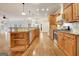 Open kitchen with island, stainless steel appliances and hardwood floors at 40 High St, Sharpsburg, GA 30277
