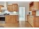 Kitchen with wood cabinetry, granite countertops, and tile backsplash at 40 High St, Sharpsburg, GA 30277