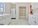 Neutral kitchen with white cabinets and countertops, a sink, and a refrigerator; includes a pantry at 40 High St, Sharpsburg, GA 30277