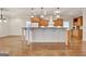 Open kitchen features a large island, hardwood floors, modern cabinetry, and granite countertops at 40 High St, Sharpsburg, GA 30277