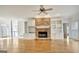 Spacious living room features a stone fireplace, built-ins, and hardwood flooring at 40 High St, Sharpsburg, GA 30277