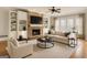 Cozy living room with a stone fireplace, built-in shelves, and neutral decor at 40 High St, Sharpsburg, GA 30277