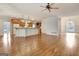 Expansive living room showcases hardwood flooring, ceiling fan, and an open floorplan to the kitchen and dining area at 40 High St, Sharpsburg, GA 30277