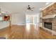 Open living space with stone fireplace, built-ins, hardwood floors, and kitchen view at 40 High St, Sharpsburg, GA 30277