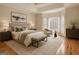 Beautifully staged primary bedroom featuring a seating area, and large windows for plenty of natural light at 40 High St, Sharpsburg, GA 30277