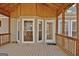 Spacious screened porch has wood ceilings and railings, with a view of a wooded lot at 40 High St, Sharpsburg, GA 30277