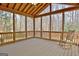 A relaxing screened porch provides an outdoor space to enjoy nature with a rocking chair at 40 High St, Sharpsburg, GA 30277