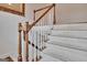 Carpeted staircase with stained wood handrail and decorative mirror at 40 High St, Sharpsburg, GA 30277