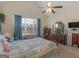 Bright bedroom with vaulted ceiling, ceiling fan, and large window with curtains at 3226 Puritan Way, Mcdonough, GA 30252