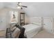 Upstairs bedroom with a sofa and a comfortable-looking bed under a ceiling fan at 3226 Puritan Way, Mcdonough, GA 30252