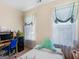 Well-lit bedroom featuring a desk, two windows and an accent pillow on the bed at 3226 Puritan Way, Mcdonough, GA 30252