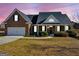 Charming brick home featuring a well-manicured lawn and inviting entrance with a wreath-adorned door at 3226 Puritan Way, Mcdonough, GA 30252