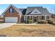 Attractive brick home showcasing a landscaped front yard and classic architectural details, including a welcoming porch at 3226 Puritan Way, Mcdonough, GA 30252