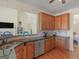 Open kitchen design with stainless steel appliances, granite counters, and wooden cabinetry, great for entertaining at 3226 Puritan Way, Mcdonough, GA 30252