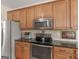 Kitchen features stainless steel appliances, granite countertops, and light wood cabinets, creating an inviting space at 3226 Puritan Way, Mcdonough, GA 30252