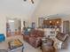 Spacious living room featuring vaulted ceilings, seamless transition to the kitchen, and plush seating at 3226 Puritan Way, Mcdonough, GA 30252