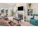 Cozy living area with a fireplace, comfortable seating, and access to the outdoors through glass doors at 3226 Puritan Way, Mcdonough, GA 30252