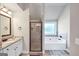 Bathroom with a vanity, framed mirror, and shower separated by a glass door at 412 Guildhouse Dr # 38, Mcdonough, GA 30252