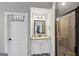 Bathroom featuring a shower, vanity, and sink with a decorative mirror at 412 Guildhouse Dr # 38, Mcdonough, GA 30252