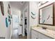 Bright bathroom with granite counters, framed mirror, and hallway view at 412 Guildhouse Dr # 38, Mcdonough, GA 30252