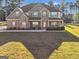 Stately two-story home with brick and stone facade, covered porch, and manicured lawn at 412 Guildhouse Dr # 38, Mcdonough, GA 30252