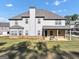 Rear exterior elevation showing a covered patio, with grill and well manicured lawn at 412 Guildhouse Dr # 38, Mcdonough, GA 30252