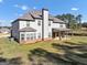 Rear exterior elevation showing a covered patio and well manicured lawn at 412 Guildhouse Dr # 38, Mcdonough, GA 30252