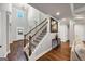 Welcoming foyer with hardwood floors, grand staircase, art, and plenty of natural light at 412 Guildhouse Dr # 38, Mcdonough, GA 30252