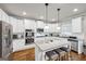 Elegant white kitchen featuring stainless steel appliances, granite countertops, and a central island at 412 Guildhouse Dr # 38, Mcdonough, GA 30252