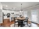 Bright, eat-in kitchen featuring stainless steel appliances, a granite island and white cabinetry at 412 Guildhouse Dr # 38, Mcdonough, GA 30252