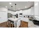 Modern kitchen featuring white cabinets, granite counters, stainless appliances, and a central island with seating at 412 Guildhouse Dr # 38, Mcdonough, GA 30252