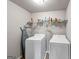 Functional laundry room featuring a washer, dryer, and storage shelves at 412 Guildhouse Dr # 38, Mcdonough, GA 30252