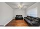 Comfortable living room features hardwood floors, crown molding, and large sofa at 412 Guildhouse Dr # 38, Mcdonough, GA 30252