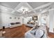 Large living room with hardwood floors, coffered ceilings, and three sofas for entertaining guests at 412 Guildhouse Dr # 38, Mcdonough, GA 30252