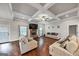 Bright living room with hardwood floors, stone fireplace, coffered ceilings, and ample natural light at 412 Guildhouse Dr # 38, Mcdonough, GA 30252