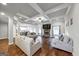 Spacious living room boasts hardwood floors, coffered ceilings, a ceiling fan, and a stone fireplace at 412 Guildhouse Dr # 38, Mcdonough, GA 30252