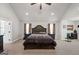 Large primary bedroom with a tray ceiling, dark wood furnishings, and ample space at 412 Guildhouse Dr # 38, Mcdonough, GA 30252