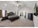 Expansive main bedroom boasting a tray ceiling, plush carpeting, and a ceiling fan at 412 Guildhouse Dr # 38, Mcdonough, GA 30252