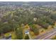 Birds-eye view of a property surrounded by dense trees with long driveway and nearby road at 470 Old Griffin Rd, Hampton, GA 30228