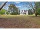 Expansive backyard view, showcasing the rear of the house with lots of green space at 470 Old Griffin Rd, Hampton, GA 30228