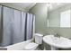 Neutral bathroom featuring a tub and shower combination and a white sink with a large mirror at 470 Old Griffin Rd, Hampton, GA 30228