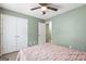 Bedroom with ceiling fan, large closet, and neutral color scheme at 470 Old Griffin Rd, Hampton, GA 30228