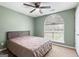 Bedroom with ceiling fan, large window, and neutral color scheme at 470 Old Griffin Rd, Hampton, GA 30228
