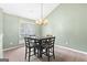 Inviting dining room with an elegant chandelier, large window and seating for four at 470 Old Griffin Rd, Hampton, GA 30228