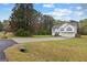 Suburban house with a driveway, set in a large grassy lot and tree-filled landscape at 470 Old Griffin Rd, Hampton, GA 30228