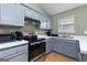 Kitchen with stainless steel oven and appliances set amongst gray cabinets and a light green wall at 470 Old Griffin Rd, Hampton, GA 30228