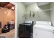 Functional laundry room with a washer, dryer, and storage shelving; adjacent to the basement at 470 Old Griffin Rd, Hampton, GA 30228