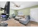 Open living area featuring a plush sofa, fan, and space for a home office or gym at 470 Old Griffin Rd, Hampton, GA 30228